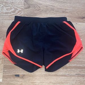 Black underarmor shorts with neon pink design. Made with quick-dry material.